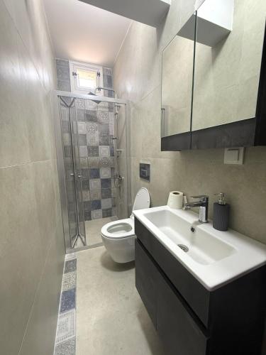 a bathroom with a sink and a toilet at Akkoç Heritage Suite by Lodhous in Ayvalık