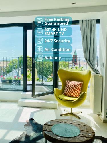 a yellow chair with a pillow in a room with a window at Angel MINT Apartment - FREE PARKING - Balcony in Krakow