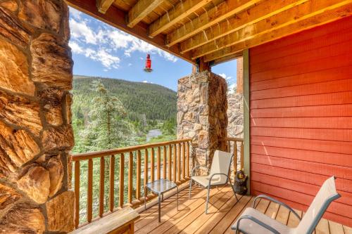 a balcony with chairs and a view of the mountains at Hidden River Lodge 5975 in Keystone