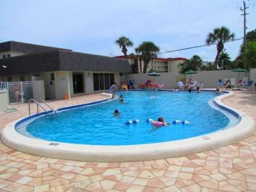 a group of people swimming in a swimming pool at Crescent Arms Condominiums in Siesta Key