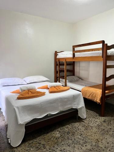 a bedroom with two bunk beds in a room at Hotel Pousada Calhau in São Luís