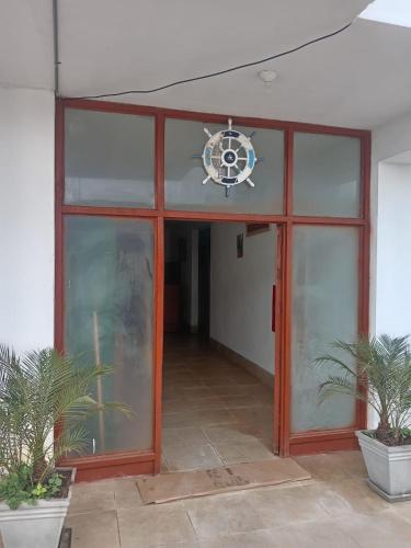 an entry to a building with a glass door at Hostal Lobitos in Cerro Azul