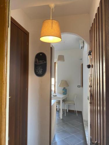 a hallway with a room with a table and a light at laCasetta 1 delight for 2 in Capranica Prenestina