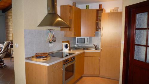 a kitchen with wooden cabinets and a sink and a stove at Apartments Mihael in Celina
