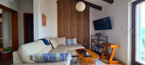 a living room with a white couch and a table at Apartments Mihael in Celina