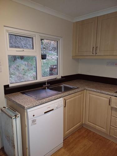 a kitchen with a sink and a counter top at Heart of Glencoe Holidays in Glencoe