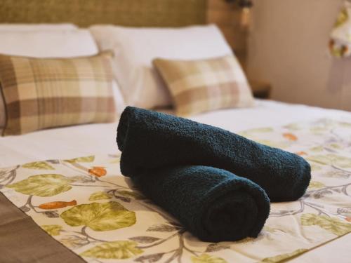 a black towel sitting on top of a bed at The Ticehurst Haven in Westgate on Sea