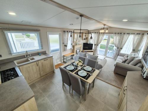 a kitchen and living room with a table and chairs at The Ticehurst Haven in Westgate on Sea