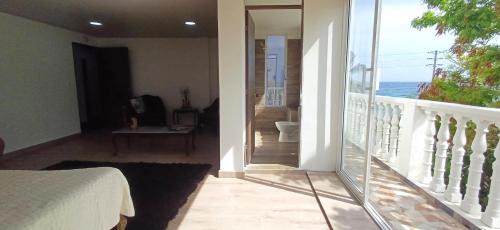 a bedroom with a balcony with a view of the ocean at Sunset Paradise in San Andrés