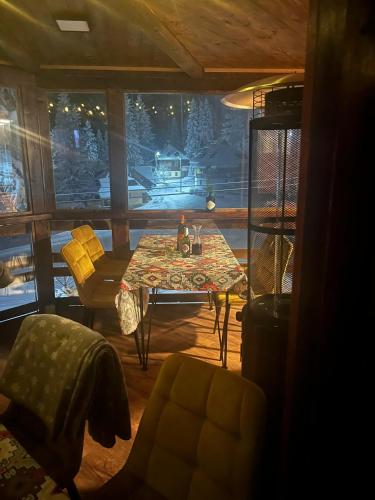 a living room with a table and chairs and a window at Whispering Pines in Šišava