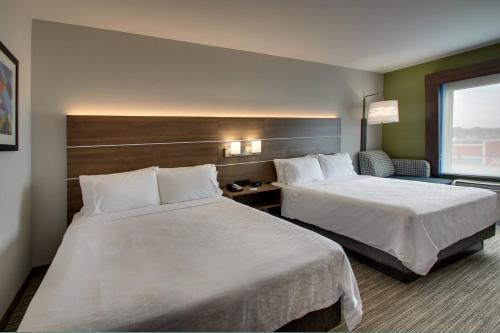 a hotel room with two beds and a window at Holiday Inn Express Hotel & Suites Carson City by IHG in Carson City