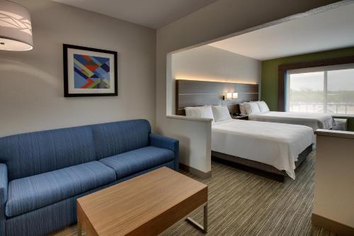 a hotel room with two beds and a couch at Holiday Inn Express Hotel & Suites Carson City by IHG in Carson City