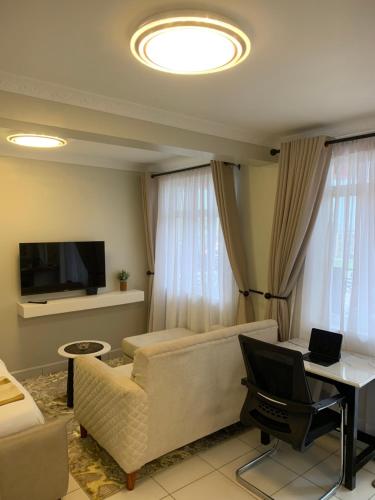 a living room with a couch and a television at Chisplace in Nakuru
