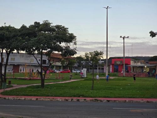 a park with people playing in the grass at Casa completa dois quartos, com ar condicionado, churrasqueira, garagem in Aparecida de Goiania