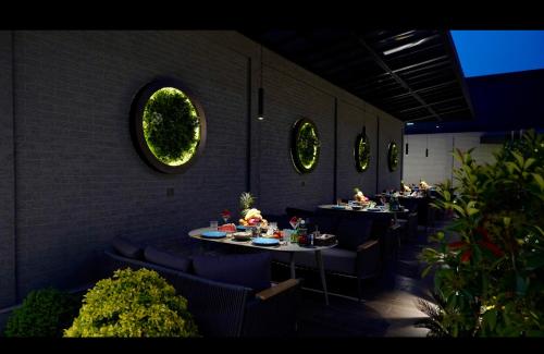 a restaurant with tables and chairs with food on them at Kiropol Hotel & Restaurant in Dushanbe