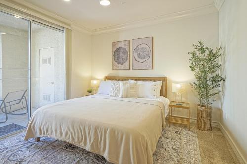 a bedroom with a large bed and a window at Dwell Descans - Restful Haven Steps to Vegas Strip in Las Vegas