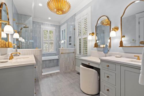 a white bathroom with two sinks and a shower at 113 Blue Heron Pond Road by Akers Ellis Rentals in Kiawah Island