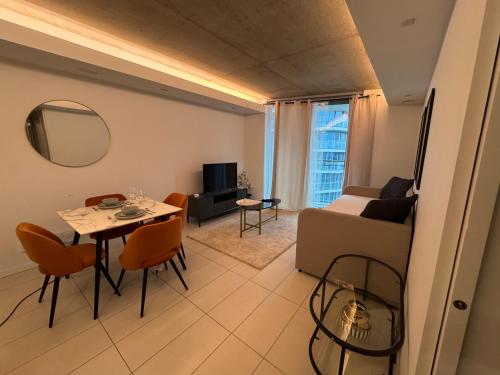 a living room with a table and a couch at High Floor Modern 1BR Stunning Views Balcony AC Free Parking in London