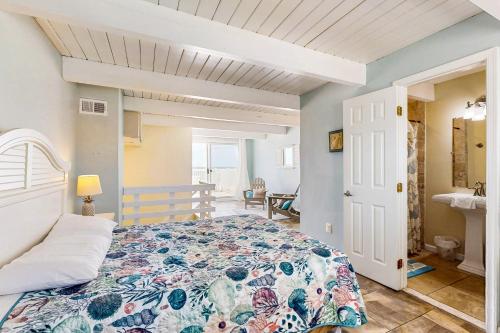 a bedroom with a bed with a floral bedspread at Ocean Colony 3 in Ocean City