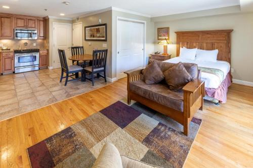 a bedroom with a bed and a couch and a table at The Residences at Biltmore - Asheville in Asheville