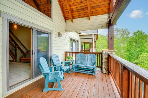 a porch with two blue chairs and a table at Mountain Condo 2 Mi to Dtwn Banner Elk with Views! in Banner Elk