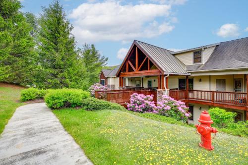 a red fire hydrant in front of a house at Mountain Condo 2 Mi to Dtwn Banner Elk with Views! in Banner Elk