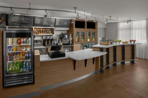a bar in a restaurant with a refrigerator at Courtyard by Marriott Santa Clarita Valencia in Valencia