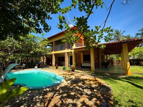 a house with a swimming pool in front of it at Casa Igarapé Atins in Atins