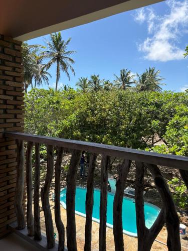 a view from the balcony of a resort with a swimming pool at Casa Igarapé Atins in Atins