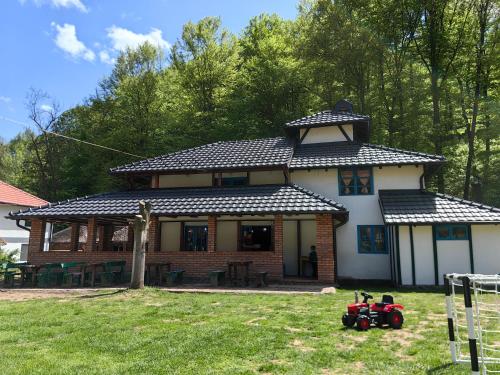 PrnjavorにあるTurističko domaćinstvo Tronoški vajatiのおもちゃのトラクターが前にある家