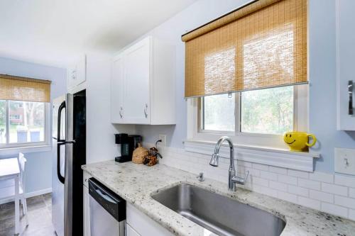 a kitchen with a sink and a refrigerator at Cozy 3-Bedroom Home in Ann Arbor in Ann Arbor