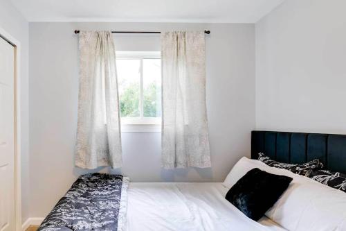 a bedroom with a bed and a window at Cozy 3-Bedroom Home in Ann Arbor in Ann Arbor