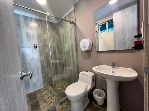 a bathroom with a shower and a toilet and a sink at Aparta estudio en el edificio bahia 79 apartasuites in Cartagena de Indias