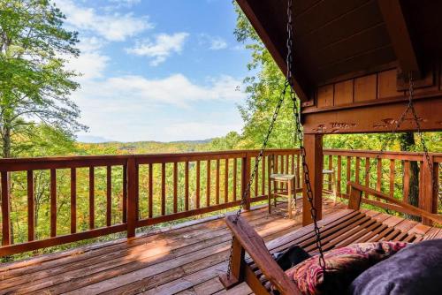 a porch swing on a cabin with a view at Cute Studio Cabin! Views! Private. Hot Tub. Relax! in Sevierville