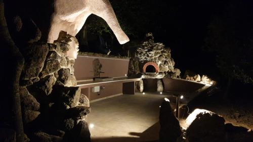 a cave with a stone building and a bath tub at Villa Veronica in Sedini