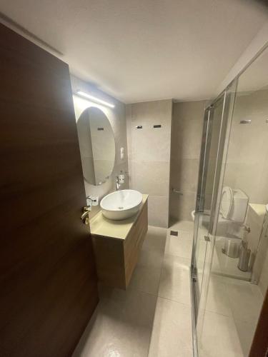 a bathroom with a sink and a shower at Iris Central Home in Kalamata