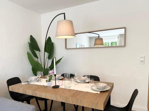 a dining room table with chairs and a mirror at LS FeWo Bad Doberan - gemütlich, praktisch, zentral in Bad Doberan