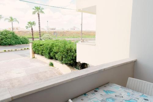 a balcony with a view of a street and palm trees at Le Stanze di Lucia vicino Ospedale Cardinale Panico a Tricase in Tricase