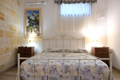 a bedroom with a bed and two night stands at Anna's House in Borgagne