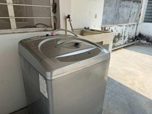 a washing machine is sitting in a room at 3 BR house 1AC y garage in Parque de la Marimba in Tuxtla Gutiérrez