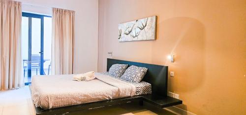 a small bed in a room with at Paceville Flat Two Bedroom Two Bathrooms St Julians with Terrace and Yard Pen 2 in St Julian's