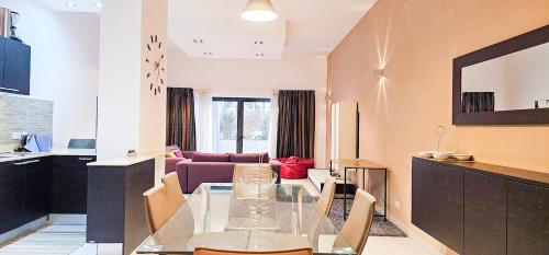 a living room with a glass table and a couch at Paceville Flat Two Bedroom Two Bathrooms St Julians with Terrace and Yard Pen 2 in St Julian's