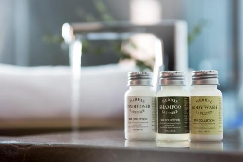 three bottles of moisturizers sitting on top of a counter at Stay Hotel Gangnam in Seoul