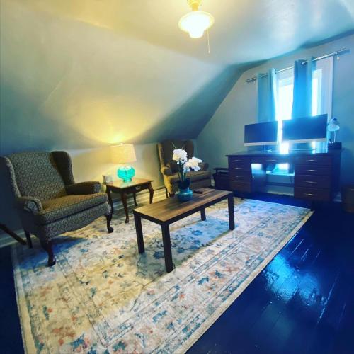 a living room with a table and two chairs and a couch at Bo's Queen Anne with Hot Tub and fenced backyard in Butte