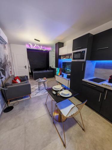 a kitchen and living room with a table and chairs at - Aux Bulles 2 - Suite & SPA - By Skyline Résidence in Limoges