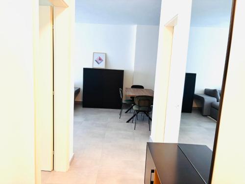 a view of a living room with a table and chairs at Apartment Sun&Sea Durres by Sasha in Durrës