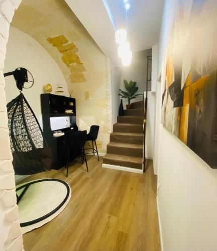 a living room with a staircase and a table at Your Exclusive Apulian Suite Near Matera in Ginosa