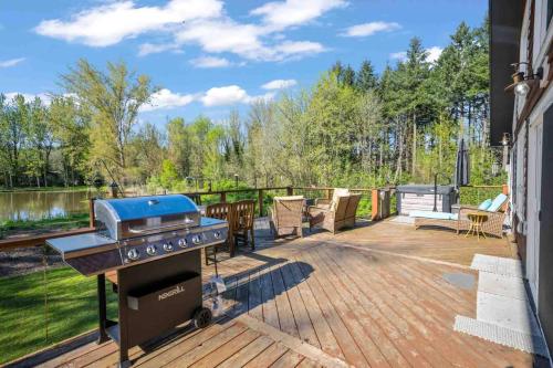 a patio with a bbq grill on a deck at Swallows Nest in Salem