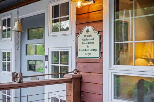 a building with a porch with a sign on it at Swallows Nest in Salem