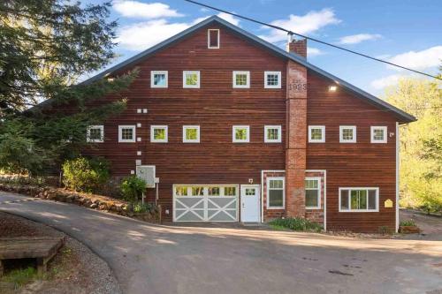 a large red barn with a garage at Swallows Nest in Salem